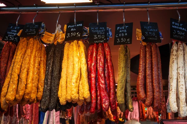 Salamis hanging at market — Stock Photo, Image