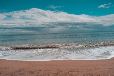 * las olas rompen en en la playa *