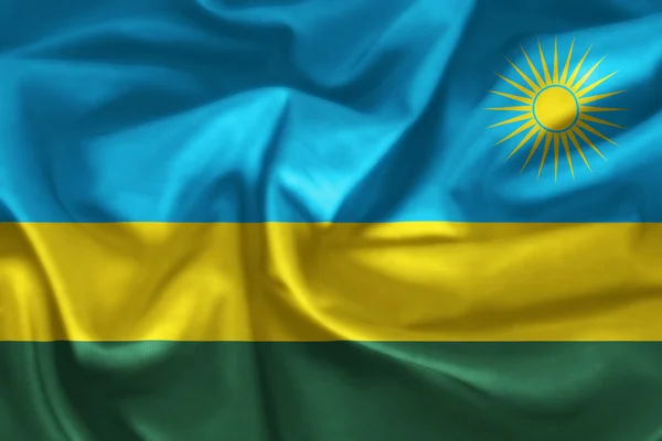 Rwandas flagga mönster på tyg konsistens — Stockfoto
