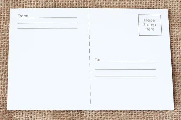 Cartões postais em branco sobre tecido marrom — Fotografia de Stock