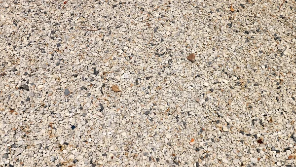 Pedra pequena textura de alfalto fundo granito preto cascalho na estrada — Fotografia de Stock