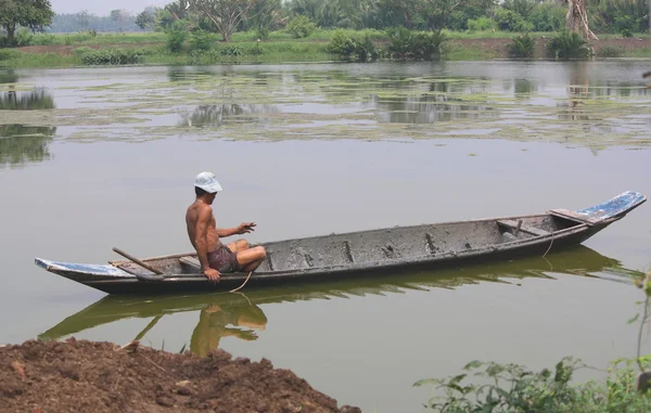 Agriculturist on a boat — Stock Photo, Image