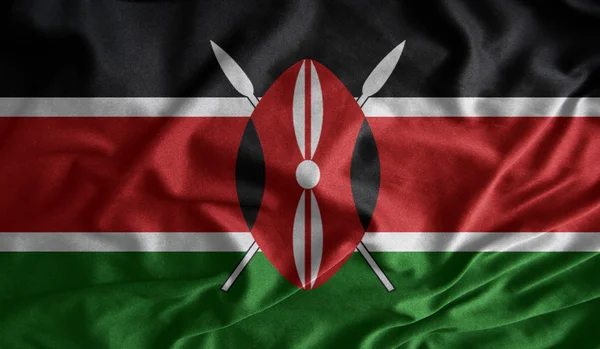 Vifta med färgglada kenyanska flaggan tyger — Stockfoto