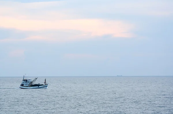 Small boat for fishermen floats in the sea — Stock Photo, Image