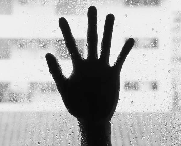 Silhouette of hand with glass, soft focus — Stock Photo, Image