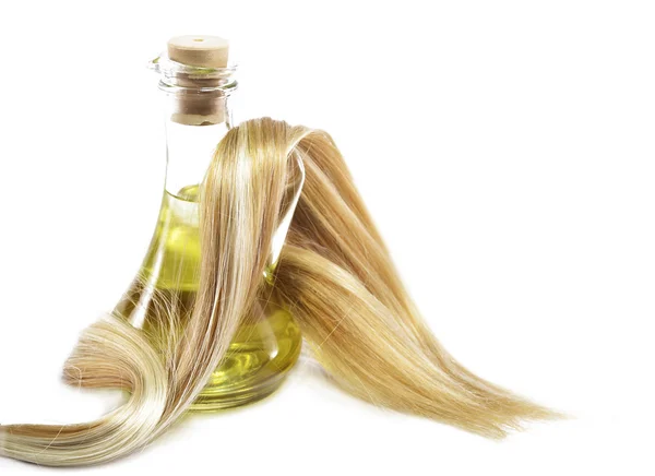 Волосы и масляная бутылка — стоковое фото
