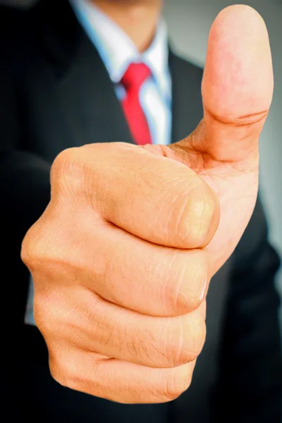Businessman showing gesturing Thumbs up. Stock Image