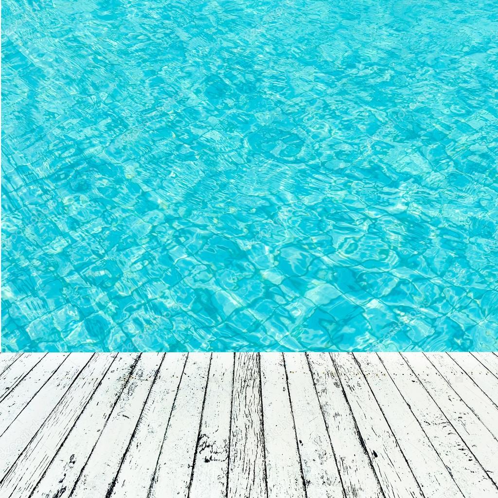wood plank under image of peaceful sea with clear sky.