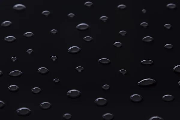O padrão de gotas de água em um preto . — Fotografia de Stock