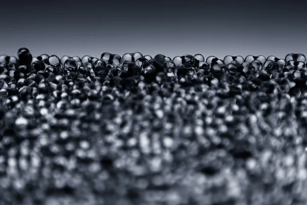 Minimalist abstract dark background with transparent glass particles. — Stock Photo, Image