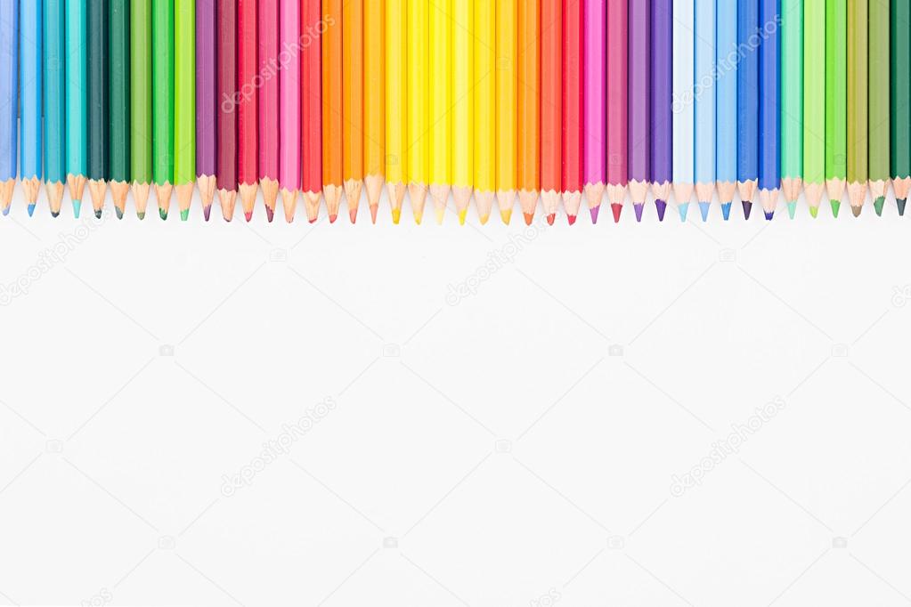 Colored pencils in rainbow order on white background. Pencils