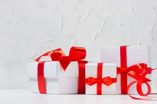 明亮的生日背景 白色礼品盒 红色蝴蝶结 卷曲缎带 白色轻盈的内部 复制空间 — 图库照片