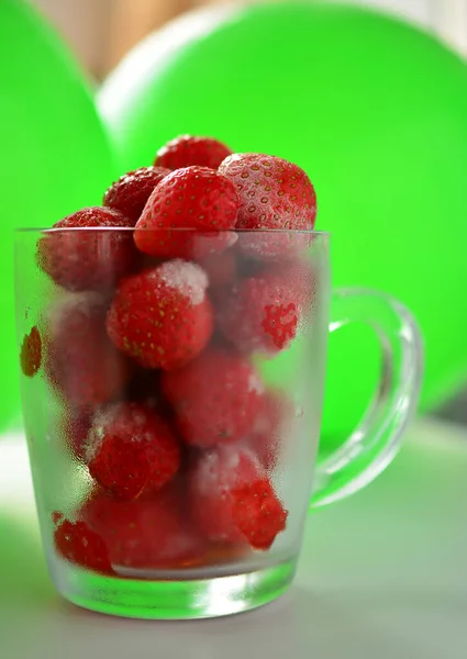 Freshly Frozen Strawberries Glass Mug White Table Background Green Balloons — Stock Photo, Image