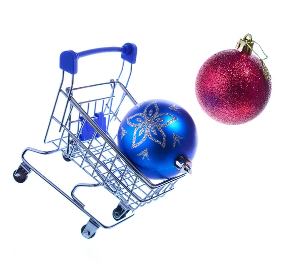 Christmas balls fly out of a tripped shopping cart on wheels. White background. copy space.