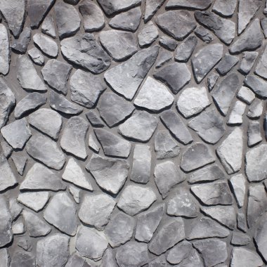 Düz taşlar ve çimentodan arka plan manzarası, doğal malzemelerden dekoratif duvar. Boşluğu kopyala.