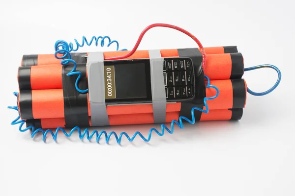 ready assembled bomb with a clockwork from an old smartphone rewound with electrical tape on a white background. terrorism concept. copy space.