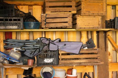 various old inventory of a country house on shelves in a barn. copy space.