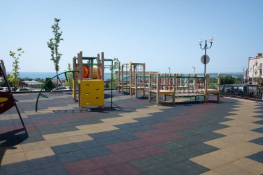 Oyun parkına karşı deniz ve sabah mavisi gökyüzü. Çocuklarla birlikte Karadeniz kıyısında dinleniyorlar..