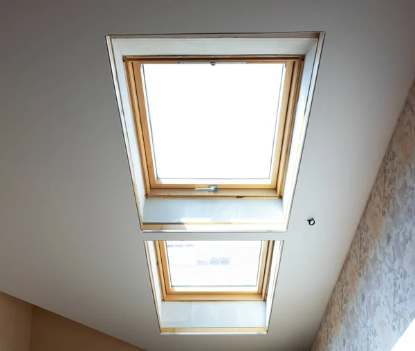 Wooden dormer windows in the attic room with bright white light — Stock Photo, Image