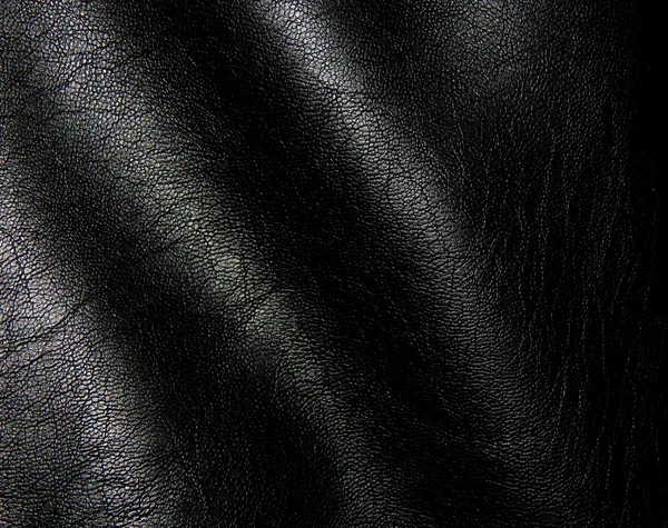 A textura de couro genuíno preto de perto — Fotografia de Stock