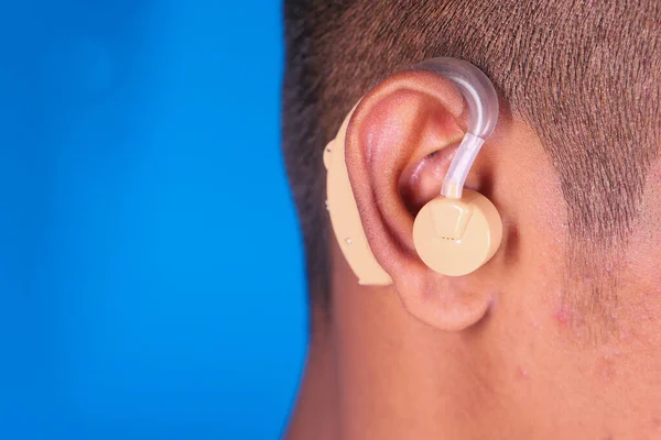 Hearing aid concept, a young man with hearing problems.