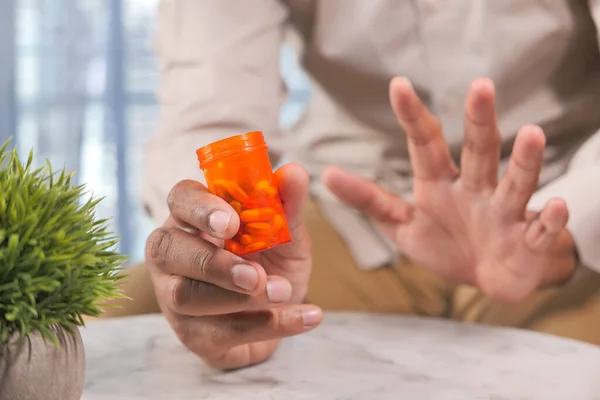 Close up of person hand holding pill container