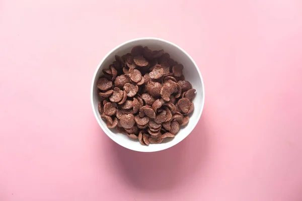 Ansicht von Schokolade Cornflakes in einer Schüssel auf rosa — Stockfoto