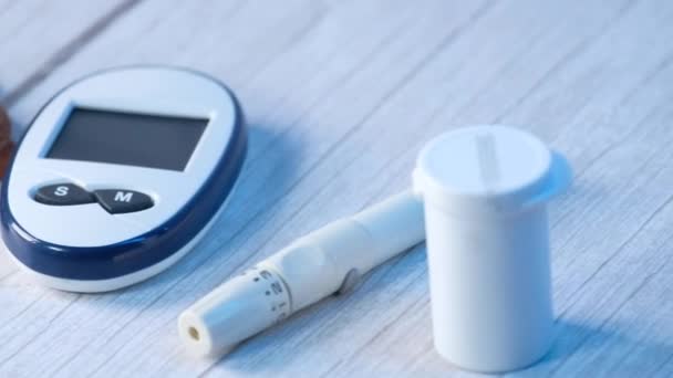 Close up of diabetic measurement tools , almond and apple on table — Stock Video