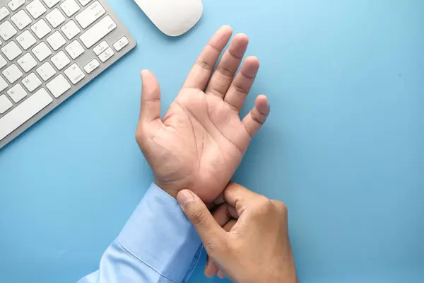 stock image  Young man in suffering wrist pain, close up 