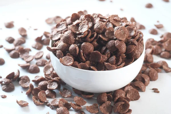 Zbliżenie płatków kukurydzianych czekolady w misce na białym — Zdjęcie stockowe