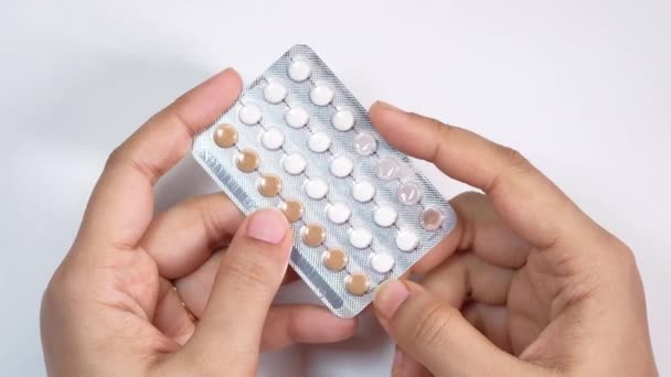 Women hand golding birth control pills close up — Stock Video