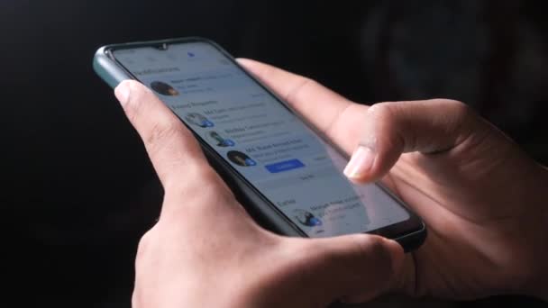 Close up of young man hand using smart phone browsing facebook — Stock video