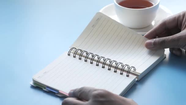 Close up of mans hand turning a pager of a diary — Stock Video