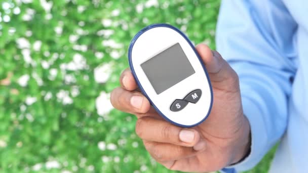 Om mână care deține instrumente de măsurare diabetică în aer liber — Videoclip de stoc
