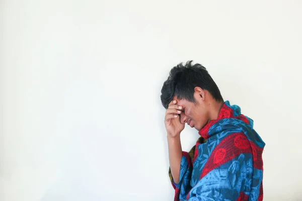 Jonge zieke man hoesten tegen witte muur — Stockfoto
