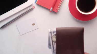 mans hand putting wallet on table 