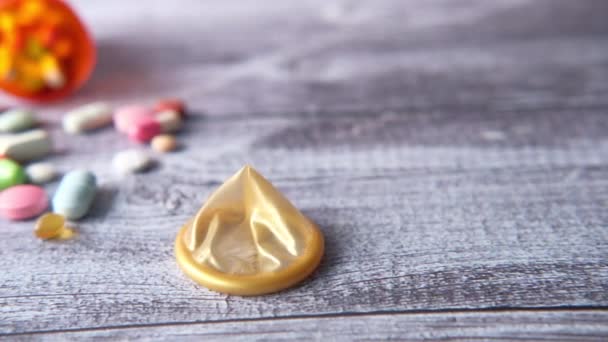 Primo piano di preservativo e pillole su sfondo di legno — Video Stock