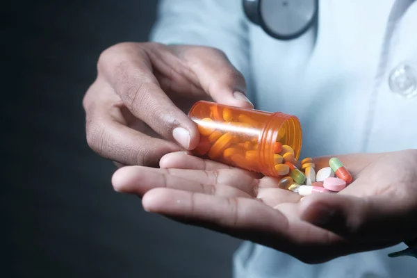 doctor hand holding pill container with copy space