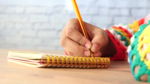 Side view of women hand writing on notepad with copy space — Stock Video