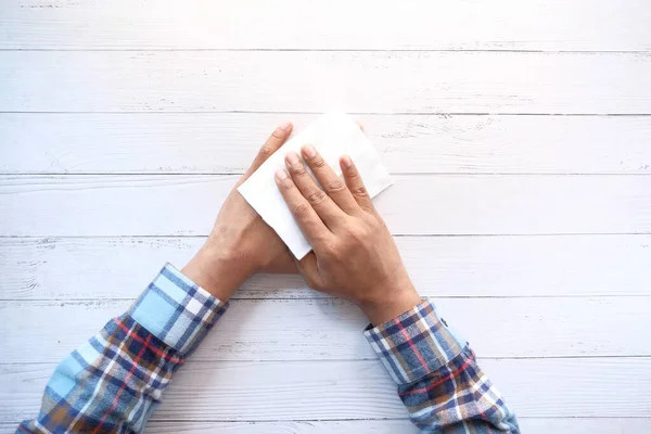 Hombre desinfectando sus manos con una toallita húmeda. — Foto de Stock