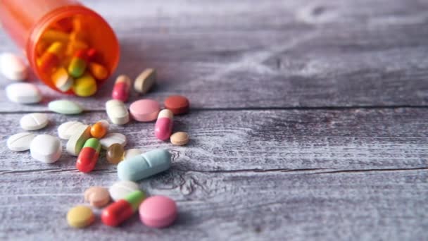 Detailní záběr mnoha barevných pilulek a kapslí — Stock video