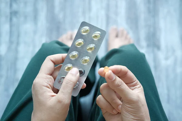 Vrouwen hand met vitamine capsules, van boven naar beneden — Stockfoto