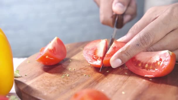 Hand Of Person Cutting Tomatoes On Chopping Board — Stock Video