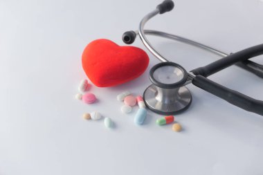 kalp şekli sembolü ve beyaz arkaplanda haplar 