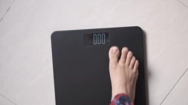  Genç kadınların ayakları ağırlık ölçeğinde 