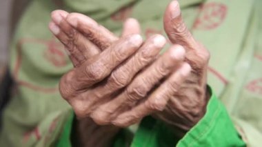 Tanınmayan yaşlı kadınların elleri bilek ağrısı çekiyor., 