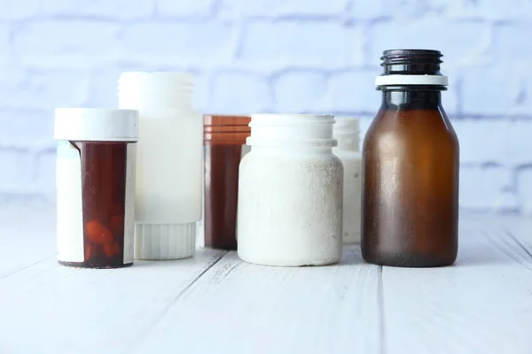 many pill container on wooden table