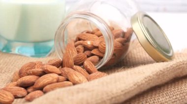 Mavi lastik eldivenler elinde sprey şişeyle masayı temizliyor. 