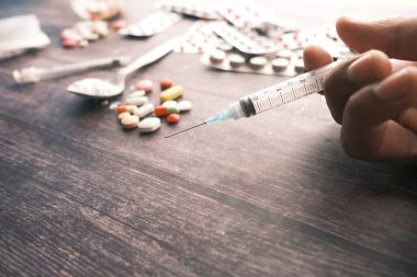 Şırınga, hap ve kapsüller masada. 