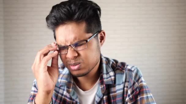 Jeune homme asiatique souffrant de forte douleur oculaire — Video